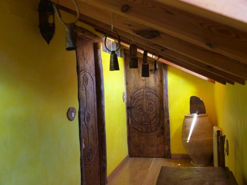 a room with a wooden door and yellow walls at O´Porron in Sabiñánigo