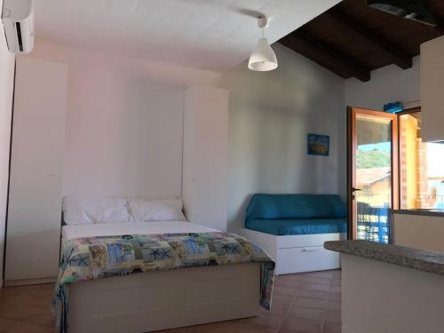 a bedroom with a bed and a blue bench at PRETTY LITTLE HOUSE (con piscina e wi-fi) in Nebida