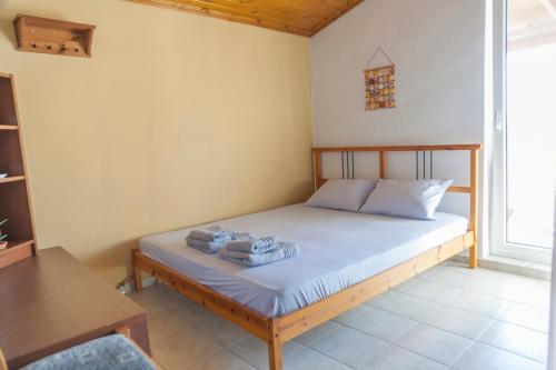 a bedroom with a bed with towels on it at Attic Anemoessa in Alexandroupoli
