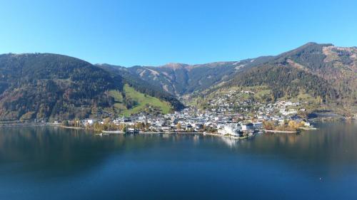 an aerial view of a town in the middle of a lake at Hotel-Garni Seestrand in Zell am See