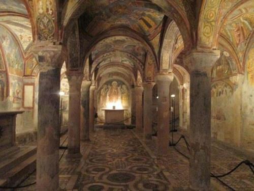 a room with a fireplace in the middle of a building at Historical Domus in Anagni
