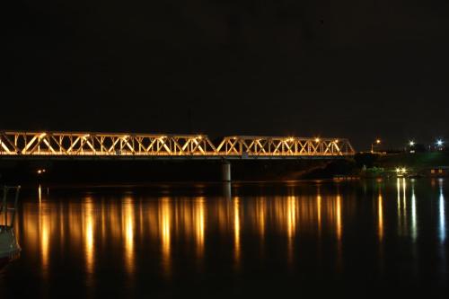 a train crossing a bridge over the water at night at Da Santo Hotel Ristorante Pizzeria in Ferrara
