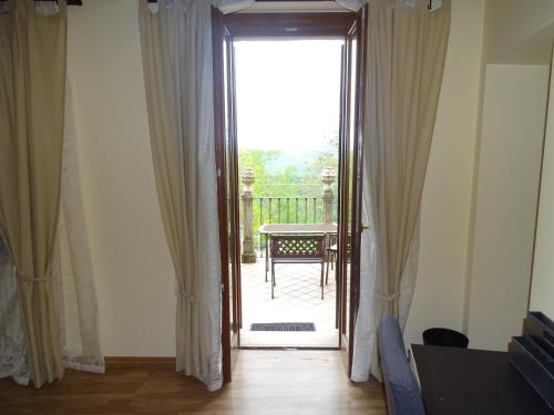 an open door to a patio with a table at Monti Azzurri in Montemonaco