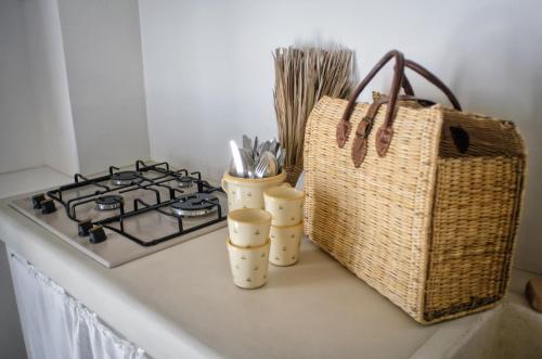 a kitchen counter with a stove and some utensils at Borgo Santa Clara in Cisternino
