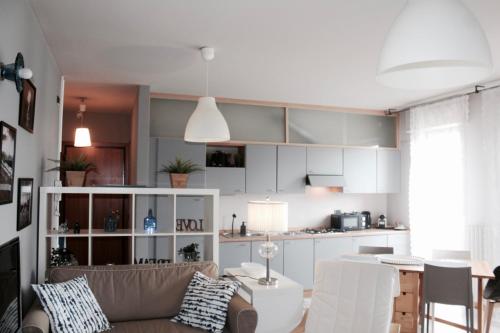 een woonkamer met een bank en een keuken bij Charming Rimini in Rimini