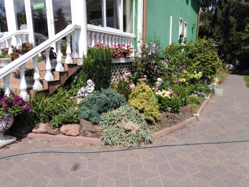 a flower garden in front of a house at VILLA GUT in Bolesławiec