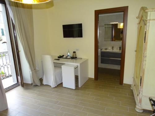 a room with a white table and a bathroom at Monti Azzurri in Montemonaco