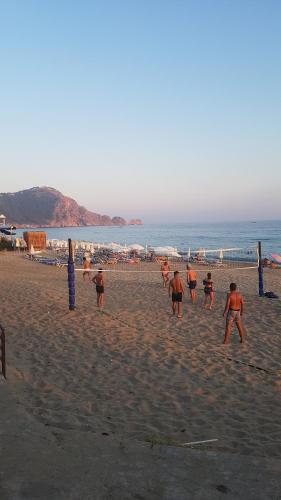 a group of people playing a game on the beach at Belle Ocean Apart Otel in Alanya