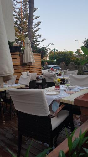 a patio with tables and chairs and an umbrella at Belle Ocean Apart Otel in Alanya