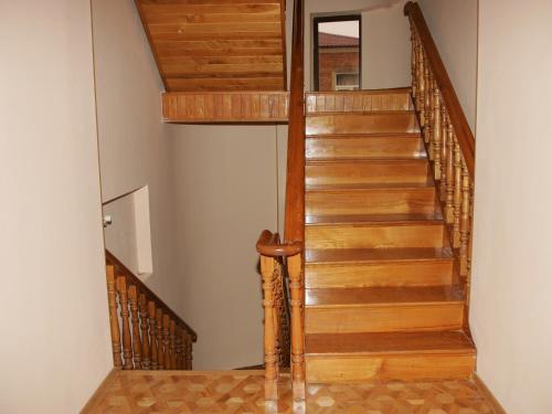 a wooden staircase in a home with wooden floors at Two Towers Guest House in Kutaisi
