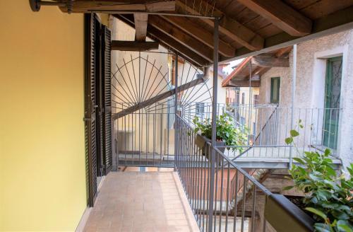 an external walkway with a metal gate on a building at Nicolaus in Sesto Calende