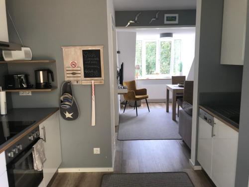a kitchen with a door leading to a dining room at Kajüte Holtenau in Kiel