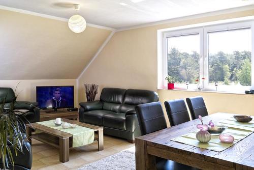 a living room with a couch and a table at Ferienwohnung Bella in Fuhlendorf
