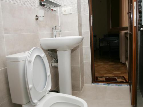 a bathroom with a toilet and a sink at Two Towers Guest House in Kutaisi