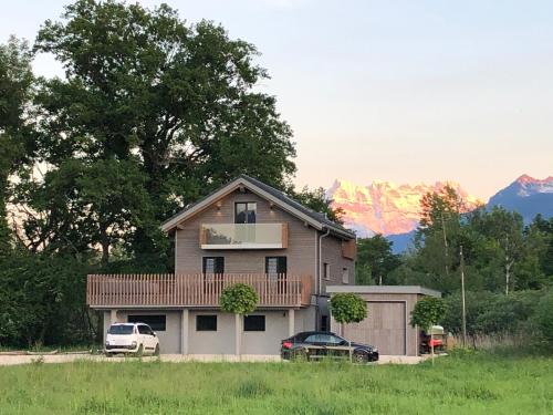 a house with a car parked in front of it at Swiss Lake Lodge in Noville