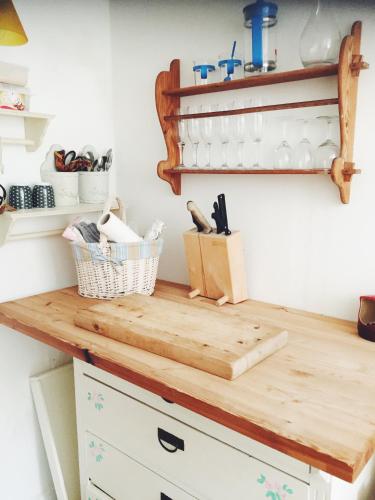 a wooden cutting board on top of a kitchen counter at Ebeltoft Midtby in Ebeltoft