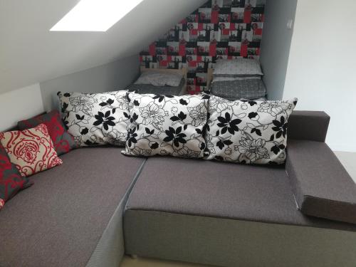 a bed with pillows on it in a room at Słoneczne Zacisze in Wicko