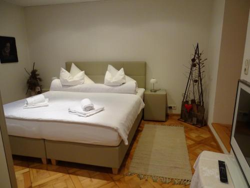 a bedroom with a bed with white sheets and pillows at Appartment Marent in Schruns