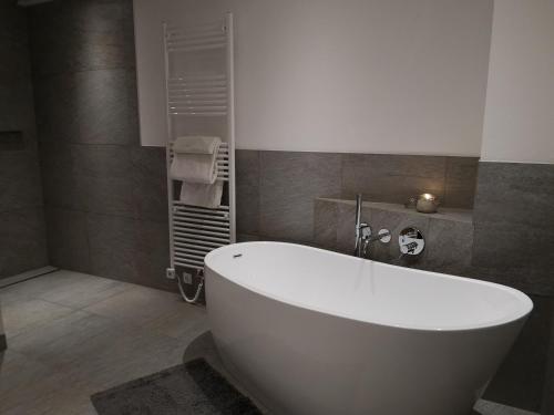 a bathroom with a white tub in a room at Appartement Klinger in Eben im Pongau