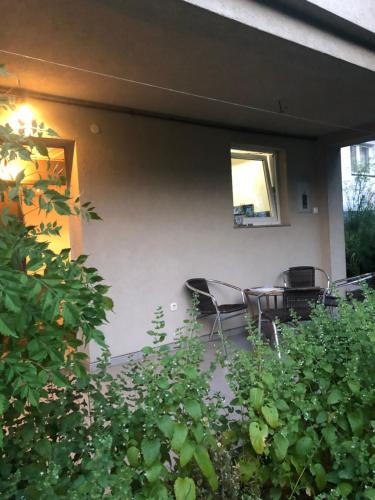 a patio with two chairs and a table and a window at Hava 2 in Sarajevo
