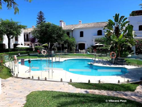 una piscina frente a una casa en Villacana Playa Elena, en Estepona