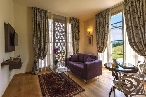 ein Wohnzimmer mit einem lila Sofa und einem Fenster in der Unterkunft Resort 37 in Rignano sullʼArno