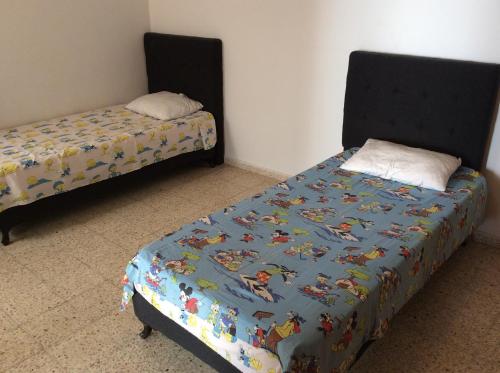 two beds sitting next to each other in a room at Mouhib Sidi Bou Saïd House in Sidi Bou Saïd