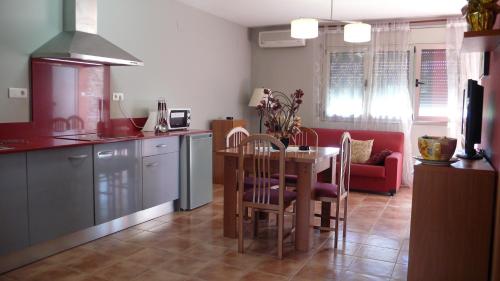 a kitchen with a table and a dining room at Mircla in Rocafort de Queralt