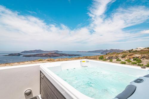 a bath tub with a view of the ocean at Caldera Stories private suites in Megalokhori
