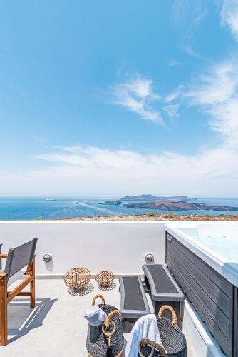 a view of the ocean from the balcony of a house at Caldera Stories private suites in Megalokhori