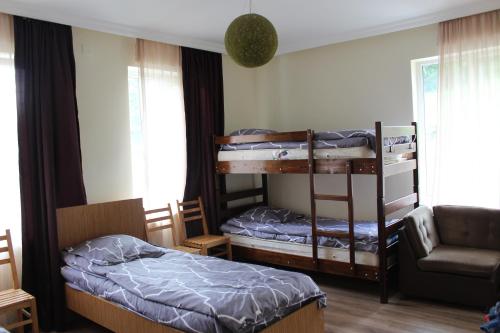 a bedroom with two bunk beds and a couch at HQ of Nove Sujashvili in Kazbegi