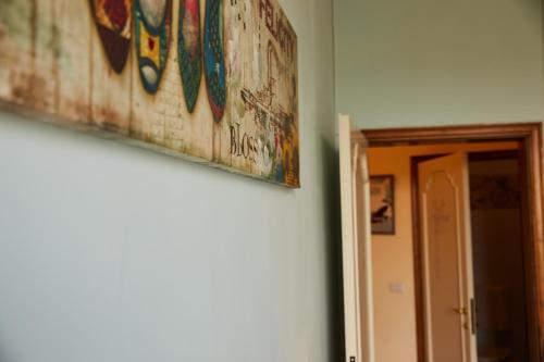 a painting hanging on a wall next to a door at Sette Note Guest House in Arezzo
