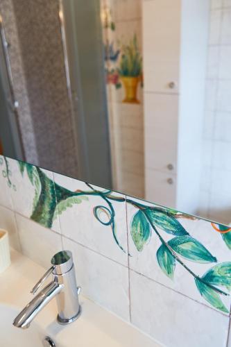 a bathroom counter with a sink with a mirror at Sette Note Guest House in Arezzo