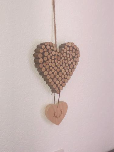 a bunch of hearts hanging on a wall at Haus am Wald in Neustift im Stubaital