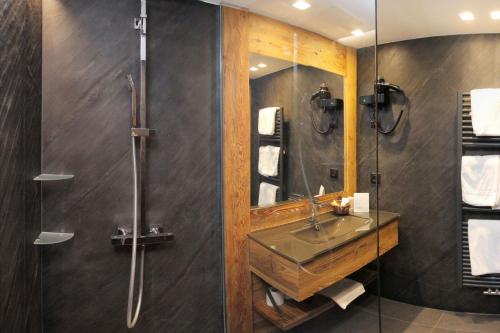 a bathroom with a sink and a shower at Hotel Cote Brune in Les Deux Alpes