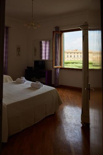 a bedroom with a bed and a large window at Sette Note Guest House in Arezzo