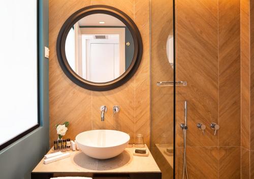 a bathroom with a sink and a mirror at Kalidon Panorama Hotel in Kokkari