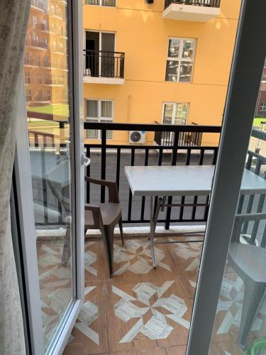 a view of a balcony with a table and chair at Квартира in Tbilisi City