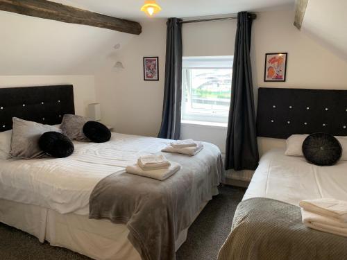 a bedroom with two beds and a window at Boars Head Boutique Hotel in Sunderland