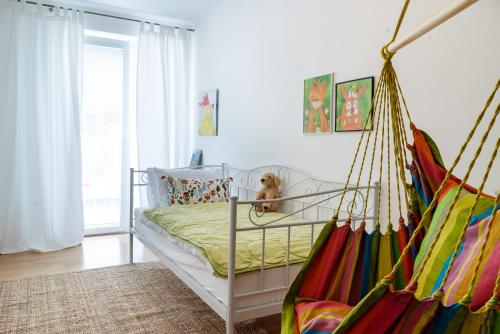 a bedroom with a swinging bed with a dog sitting on it at Apartmán Štefánka in Púchov
