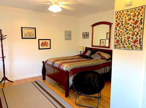 a bedroom with a bed with a mirror and a fan at Micosta Leisure Inn in Hudson
