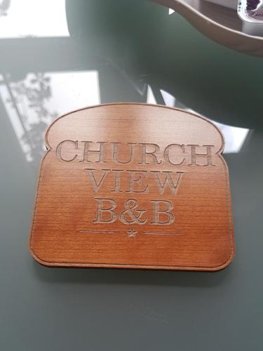 a wooden sign that says church view bc on a table at Church View House F56H977 in Gorteen