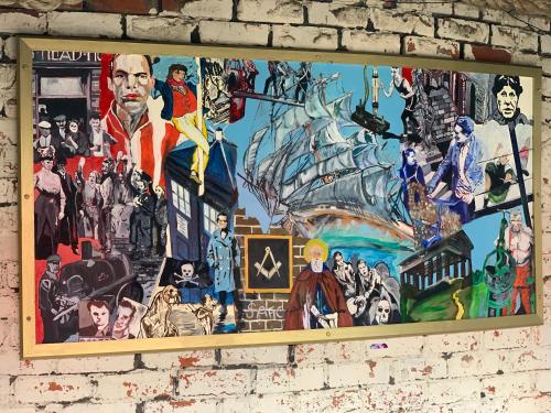 a mural on a brick wall with a painting on it at Boars Head Boutique Hotel in Sunderland