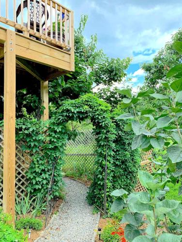 a garden with a wooden walkway and a balcony at Micosta Leisure Inn in Hudson