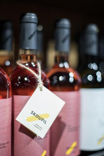 a group of bottles of wine on a shelf at Rodinné Vinařství Skoupil in Velké Bílovice