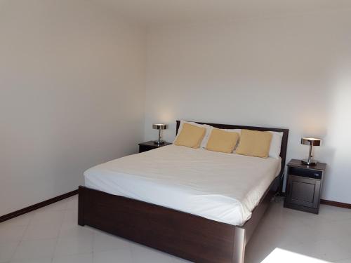 a bedroom with a large bed with two night stands at Penthouse with panoramic view in Vilamoura