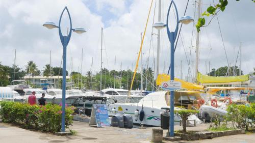 a group of boats docked in a marina at Ocean BAYALOCATION in LʼAnse Mitan