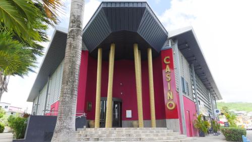 a building with surfboards on the side of it at Ocean BAYALOCATION in LʼAnse Mitan