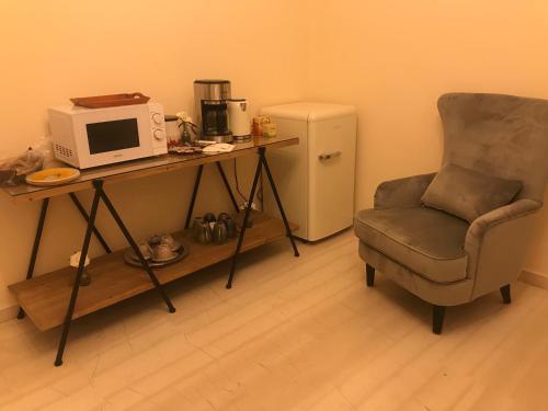 a room with a desk with a microwave and a chair at Terpsichore Boutique Appartments in Dassia