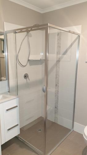 
a bathroom with a shower stall and a toilet at NRMA Victor Harbor Beachfront Holiday Park in Victor Harbor
